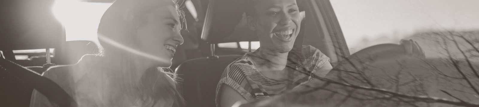 Two women enjoy a drive.