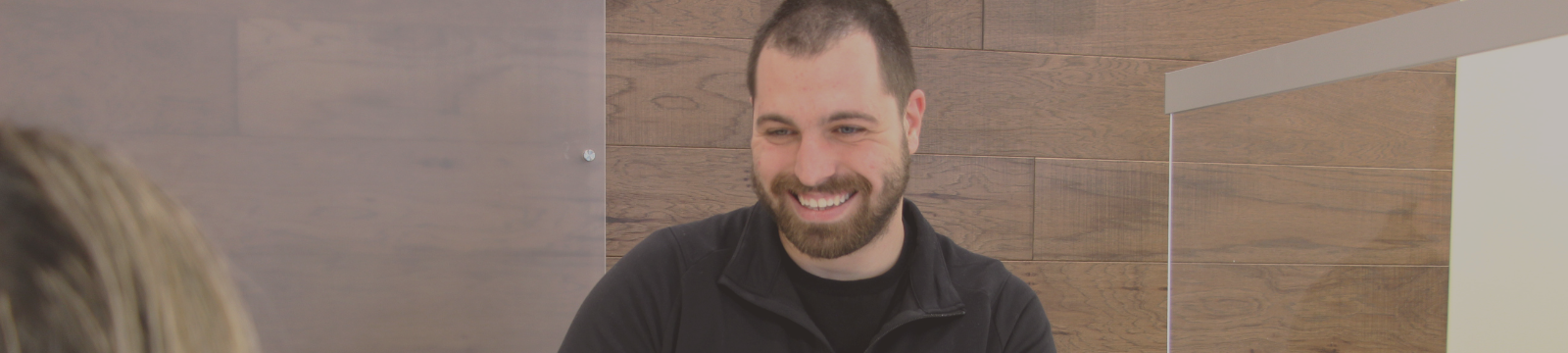 CHROME team member smiling behind teller counter