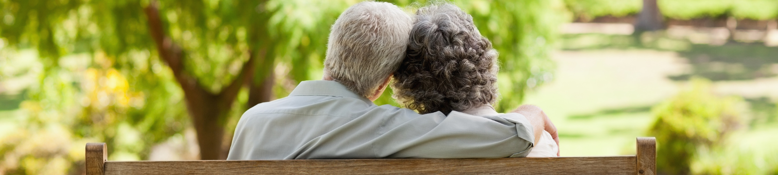 an older couple sitting at a park