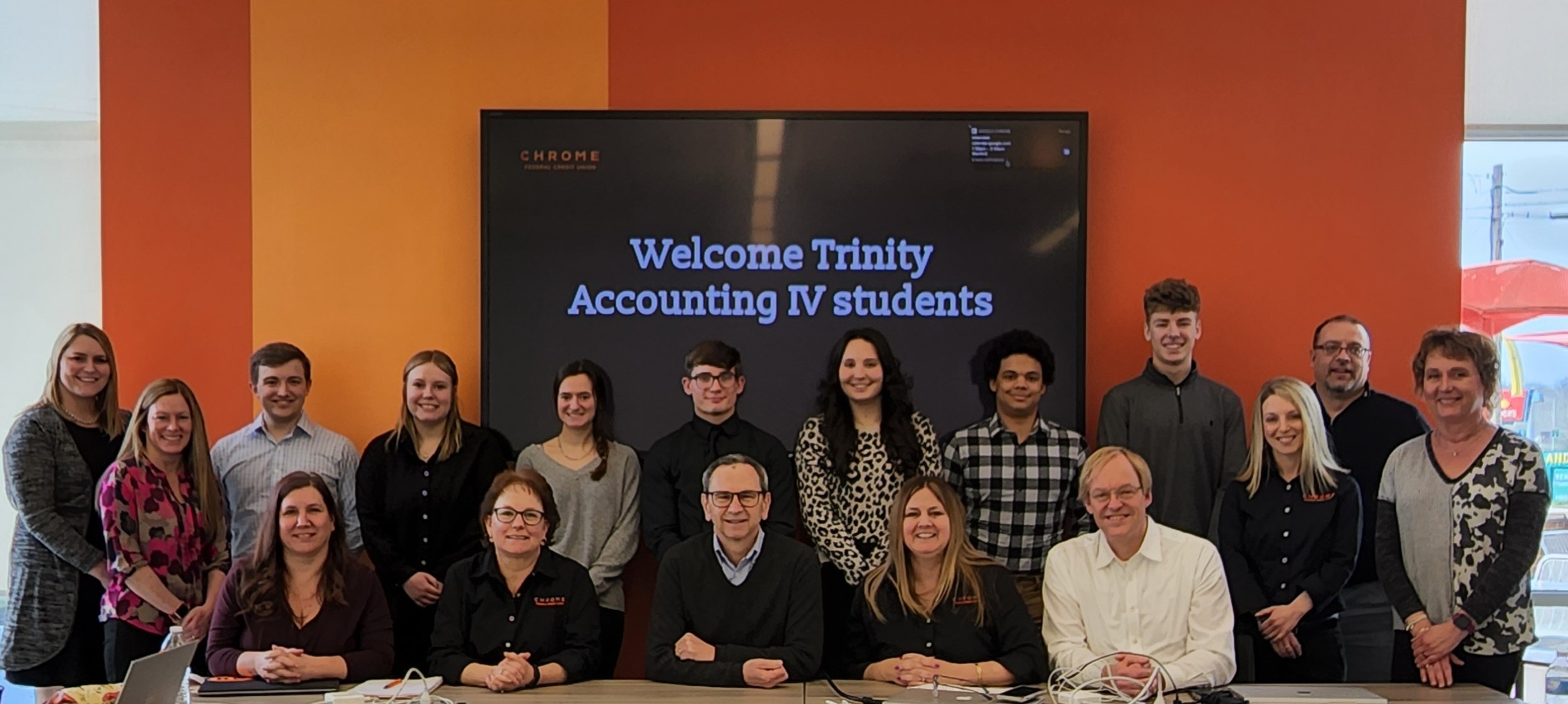 Group photo of CHROME employees and Trinity High School students and teachers at event hosted by CHROME
